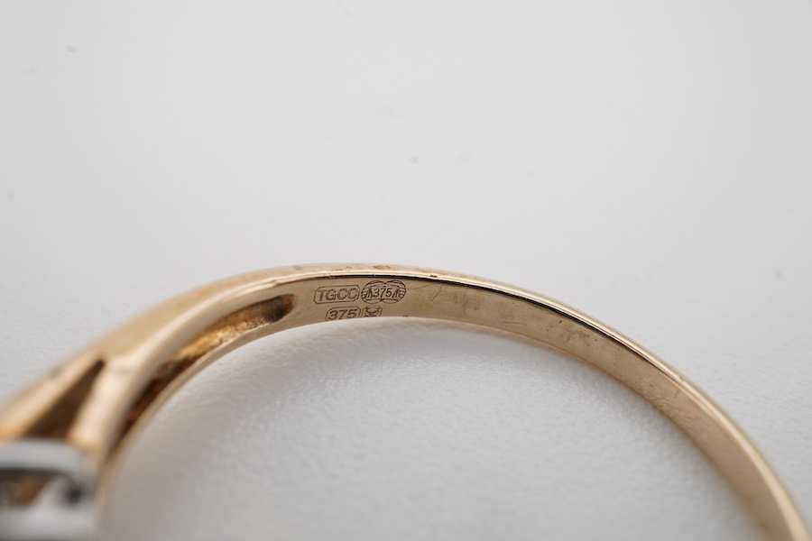 A modern 9ct gold and diamond half hoop ring, set with two graduated rows of seven diamonds, size M/N, gross weight 3.1 grams. Condition - fair to good